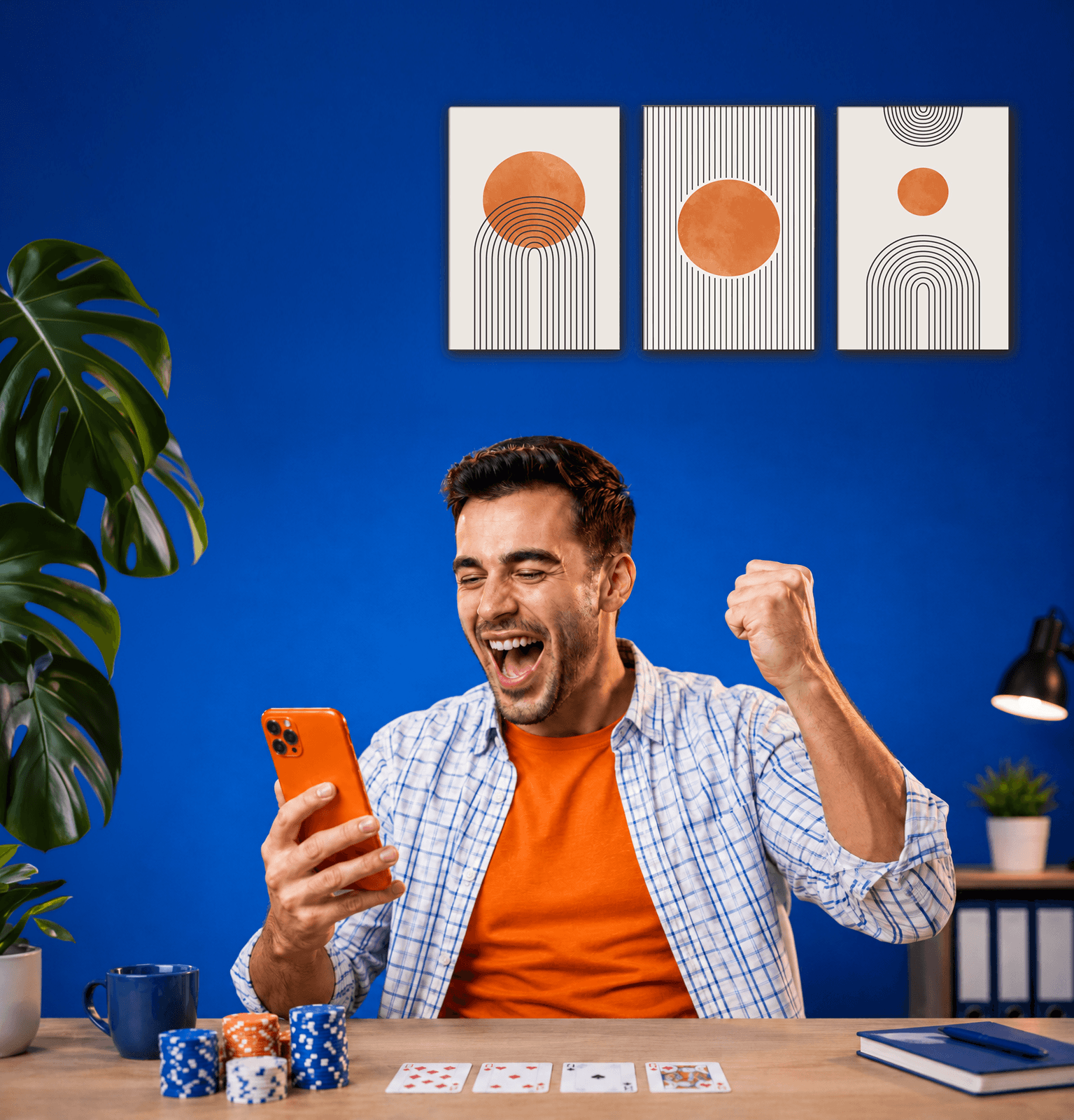 Online casino player celebrating a win on a smartphone with poker chips and playing cards on the table